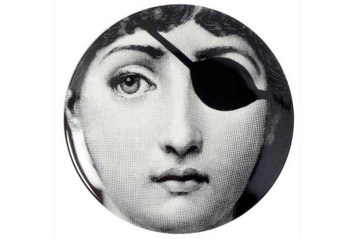 Die Augenklappe erinnert an Piraten. Der Teller ist aber dennoch ein unverkennbares Stück von  fornasetti.com.